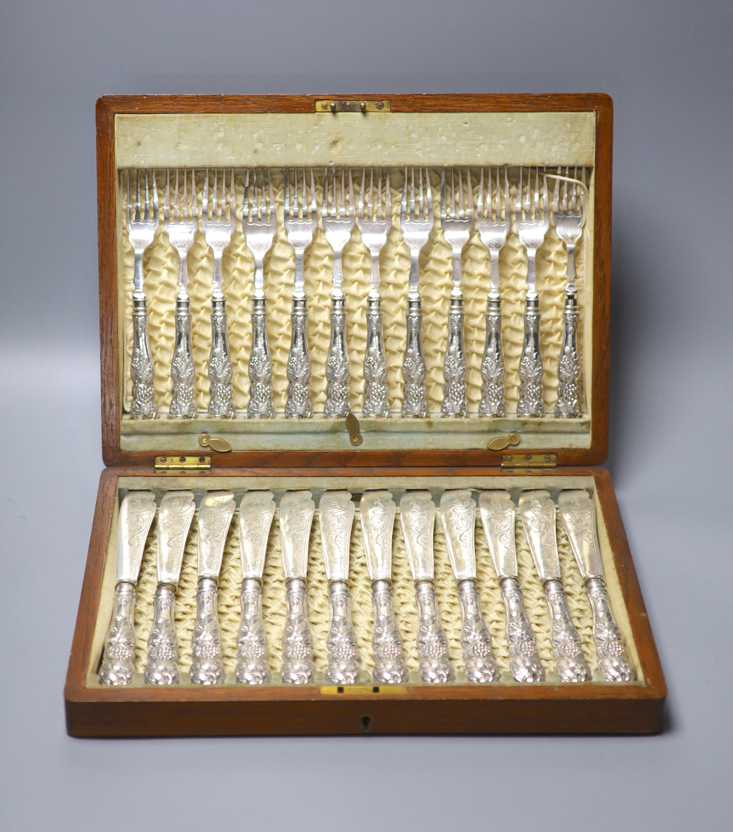 An Edwardian cased set of twelve pairs of silver handled fish eaters, John Biggin, Sheffield, 1907, case 35cm.